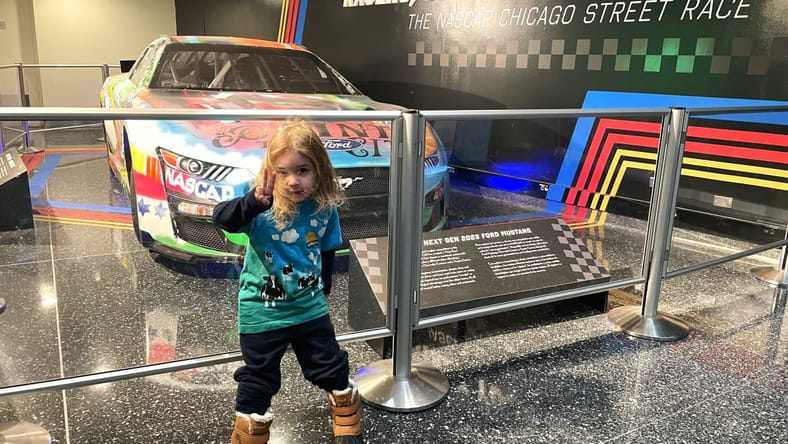 From the Mouths of Babes: 6 Things My Nephew and Niece Love About NASCAR… and Now I Do, Too 3 My Son Standing In Front Of A Nascar Race Car