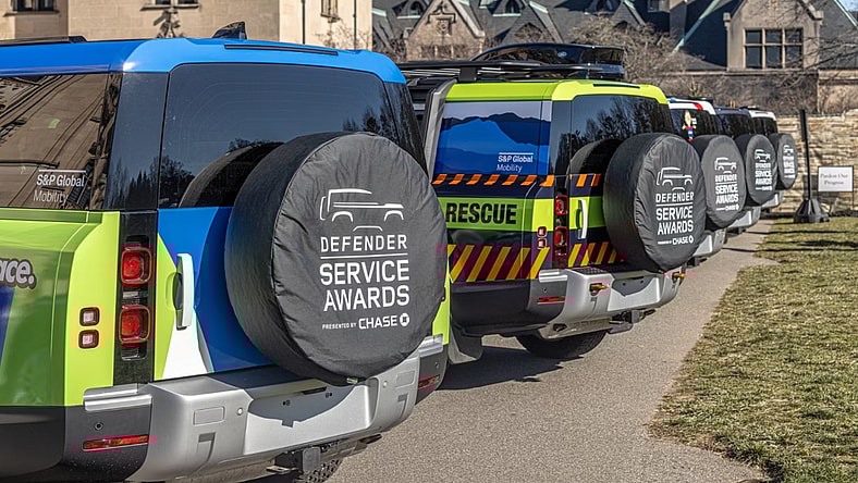 Land Rover Defender Service Award Trucks In A Line