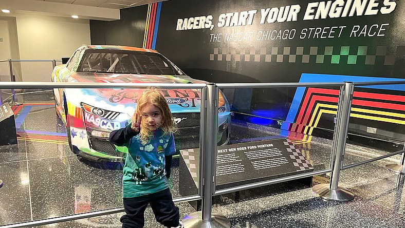 My Son Standing In Front Of A Nascar Race Car