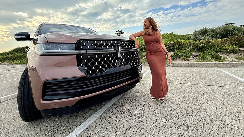 Kim Smith Standing Next To A Lincoln Navigator Black Label