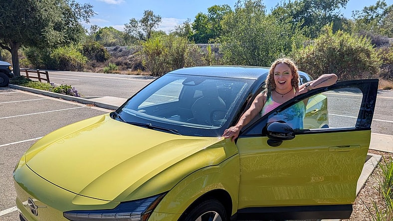 Liv Standing With The 2025 Volvo Ex30 In Moss Yellow