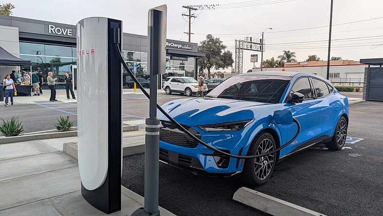 A Mustang Mach-E Charging At A Public Charger Outside A Business