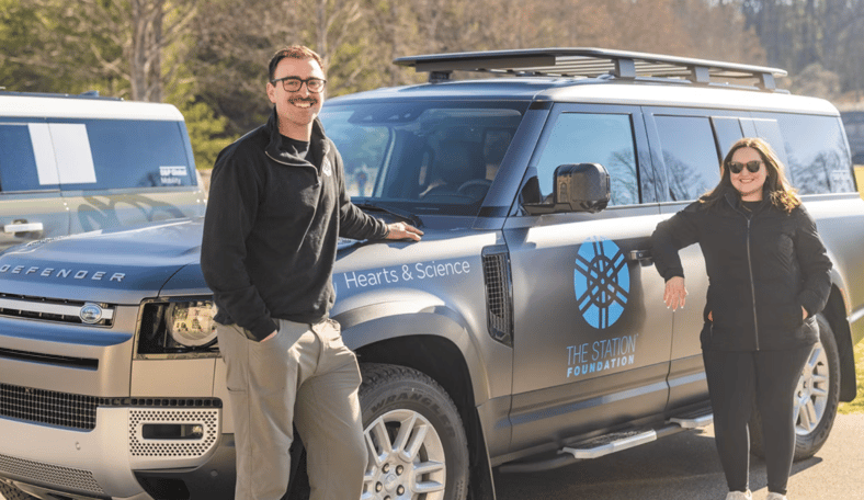 Built to Serve: How Community Heroes Can Win a Land Rover Defender 130 and $30,000 6 Two People Standing Next To A Custom Land Rover Defender 130 For The Defender Service Awards