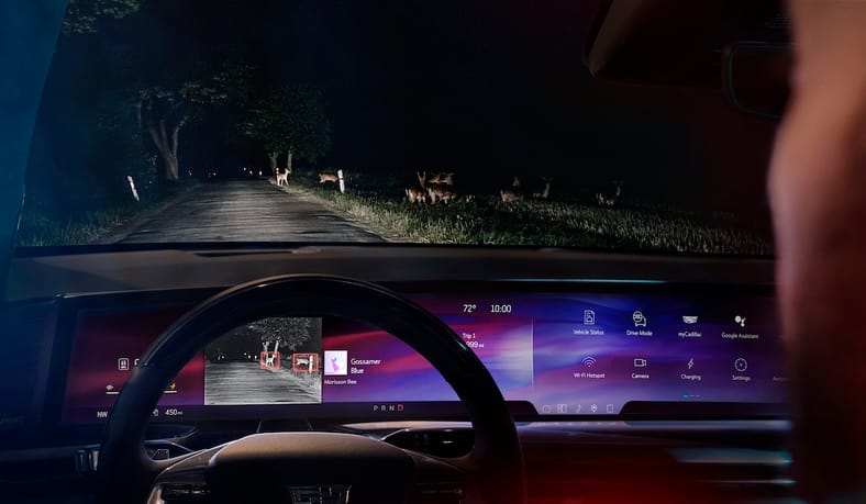 Front-facing view of the pillar-to-pillar screen in the Cadillac ESCALADE IQ Sport at night with night vision activated.