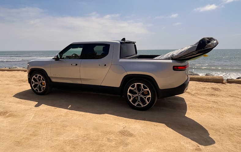 The Non-Polluting Rivian R1T Suits The Surfer'S Environmental Considerations And Is A Great Car For Traveling With A Dog