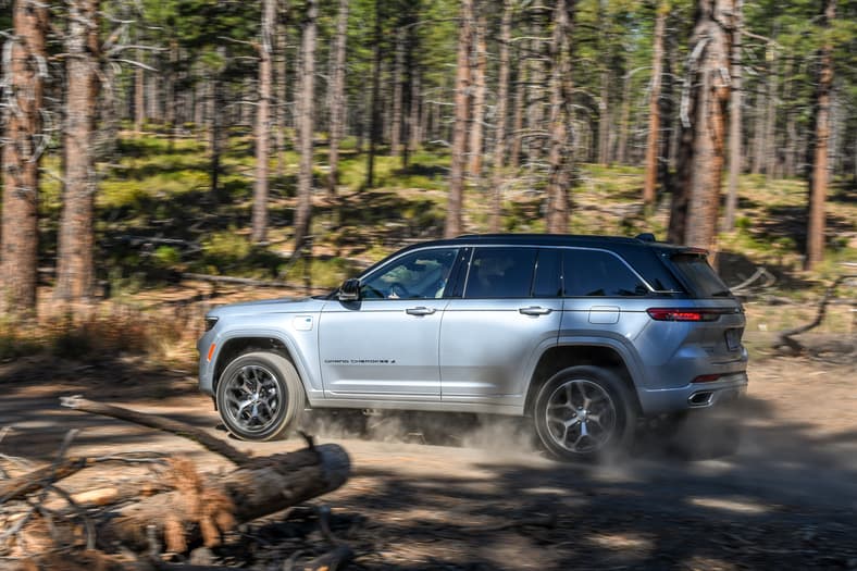 New Or Used? The Best Hybrid SUVs and What They Cost New and Used 13 A Side Shot Of The 2025 Jeep Grand Cherokee 4Xe Summit Reserve Driving Off-Road