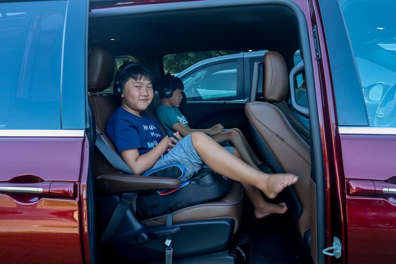 From Tots to Teenagers: Years Later, Our Minivan Still Meets Our Family's Needs 5 My Two Sons Sitting In A Minivan I Reviewed