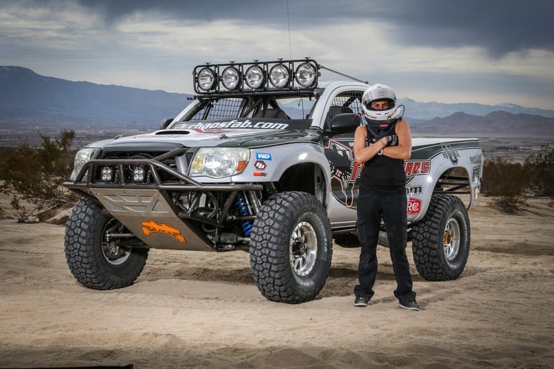 When "Total Chaos" Is Your Job: How Nicole Pitell-Vaughan Became the Go-To Builder for Off-Roaders 11 Nicole Standing Next To A Built Truck