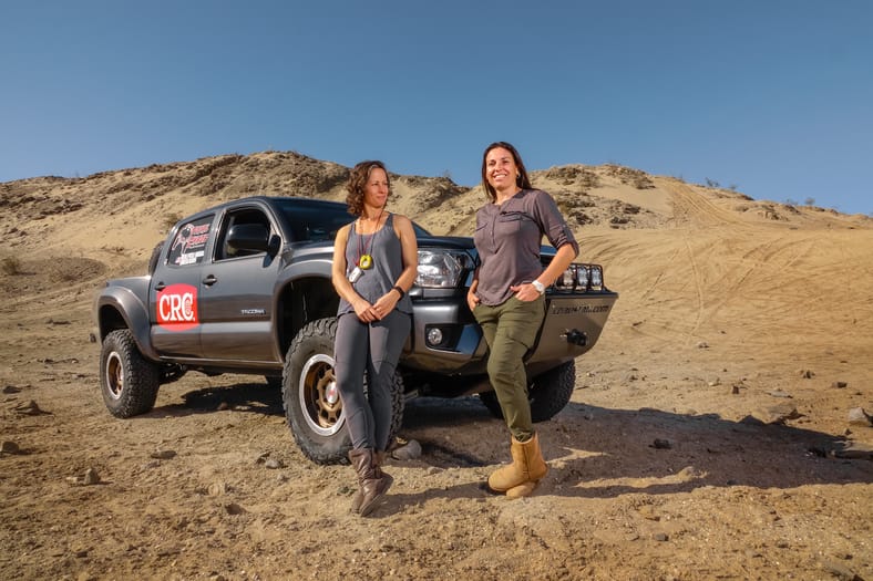 When "Total Chaos" Is Your Job: How Nicole Pitell-Vaughan Became the Go-To Builder for Off-Roaders 9 Nicole Pitell-Vaughn Standing Next To One Of The Built Trucks From Her Company