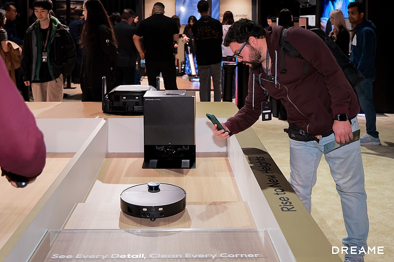 An Attendee Taking A Picture Of A Dreame Smart Bot