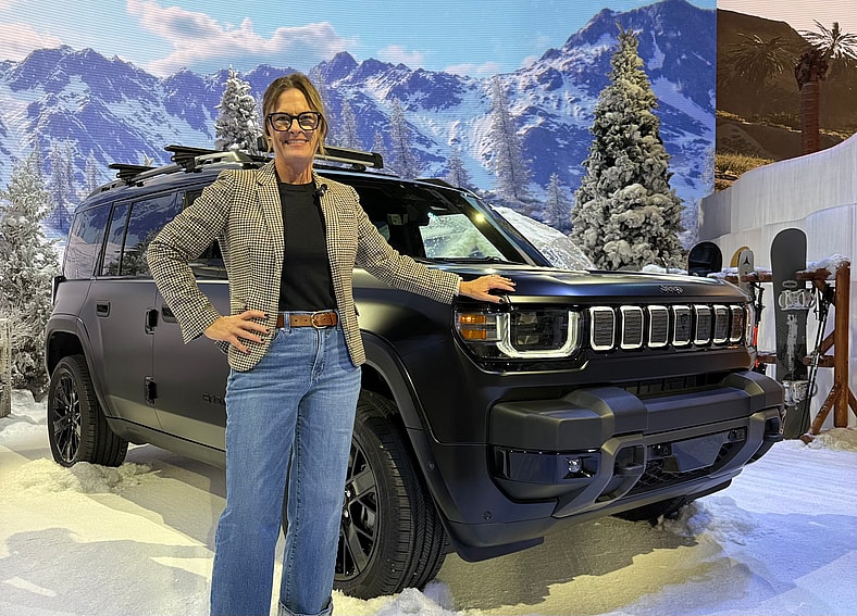 Sara Lacey Standing With The New Jeep Recon Ev Suv