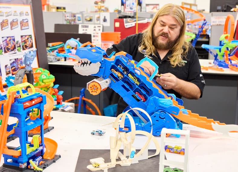 Paul Schmid, Associate Manager Product Design, Plays With The T-Rex Hot Wheels Carrier Toy