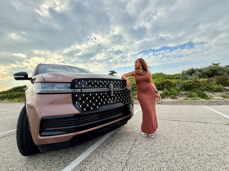 Kim Smith Standing Next To A Lincoln Navigator Black Label