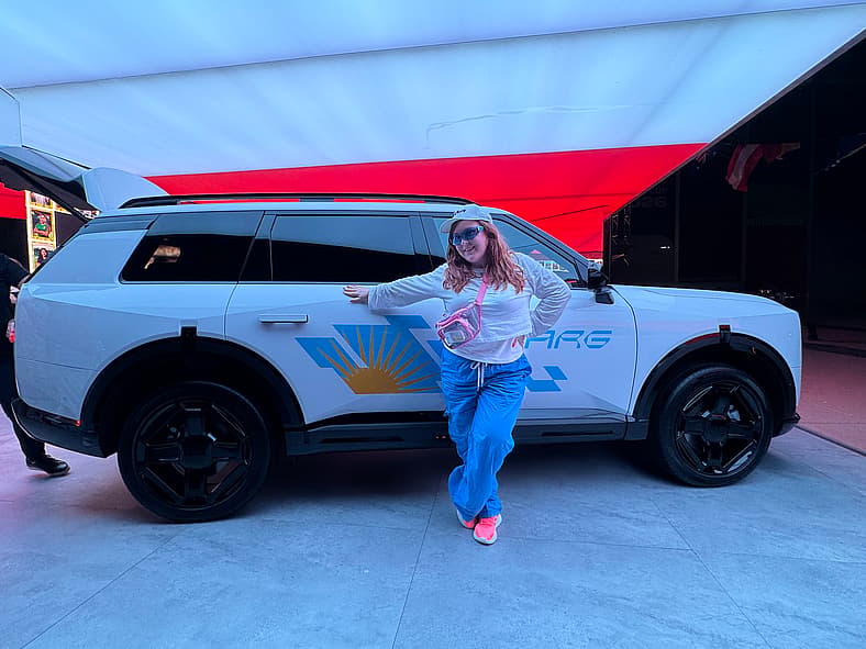 Natalie Standing Next To A Fifa Wrapped Kia Telluride