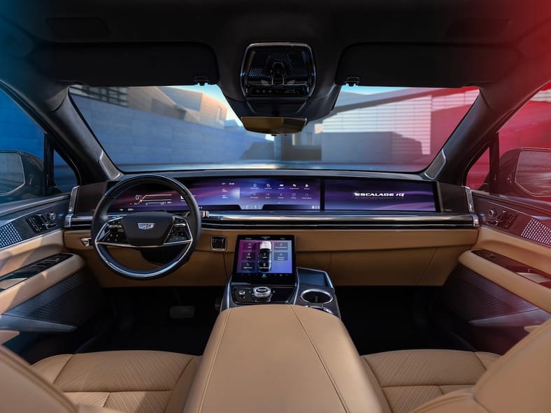 Forward-facing view of Cadillac ESCALADE IQ interior and 55-inch pillar-to-pillar screen from the rear seat.