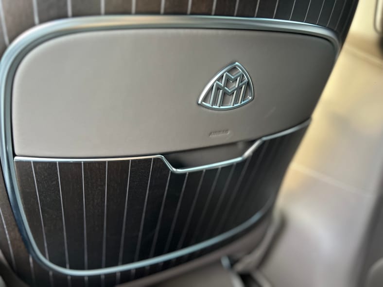 What Its Like to Drive the World's Fanciest Mercedes-Benz: Mercedes-Maybach EQS 680 Test Drive 9 The Maybach Logo On The Seat Back Pocket