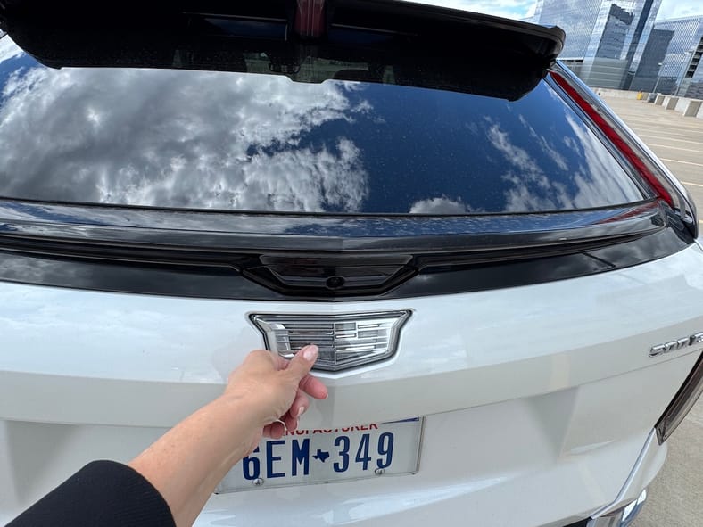 The Cadillac Badge Doubles As A Latch Release For The Lift Gate