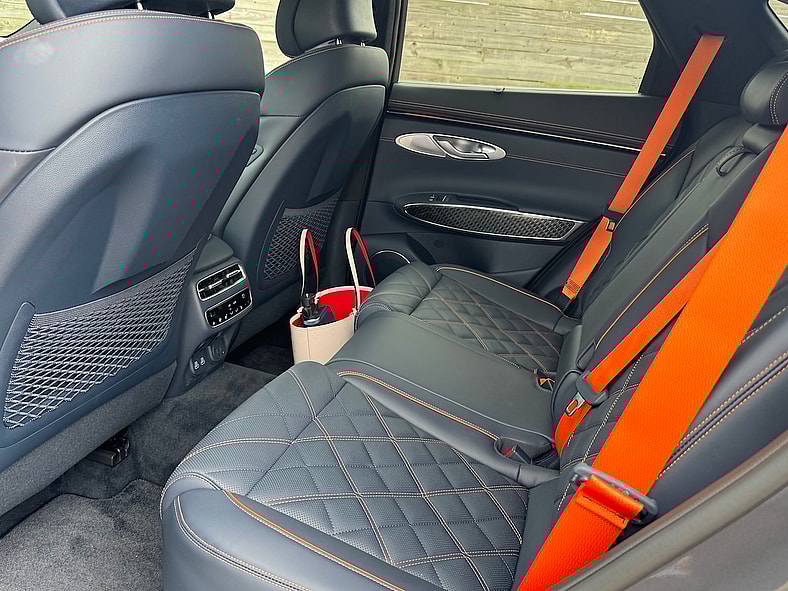 Orange Stitching And Seatbelts Are Featrured On The 2026 Genesis Gv70 Sport Prestige Model