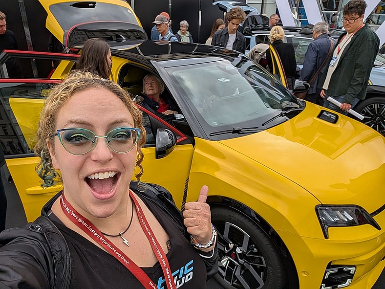 Standing Next To A Bright, Yellow, Ev