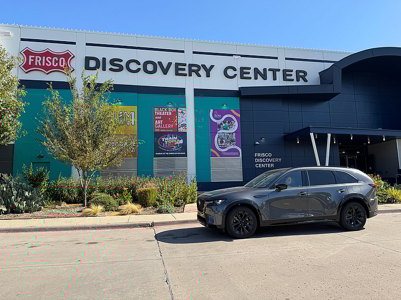 The Front End Of The 2026 Mazda Cx-90 3 Row Suv In Front Of The Family Destination