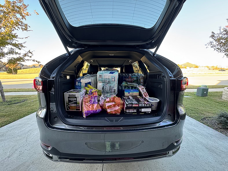 The Trunk Of The 2026 Mazda Cx-90 3 Row Suv With The Trunk Full Of Groceries