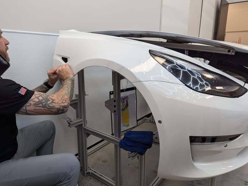 A Student Applying Paint Protection Film At The Xpel Lab