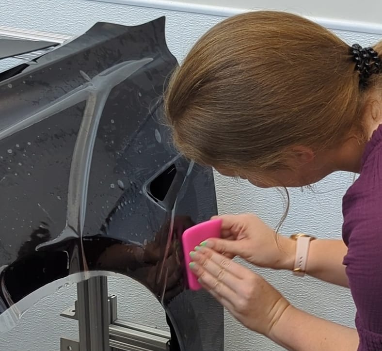 Never Buy These Things From a Car Dealer—Or Pay For Them When You Purchase a Car 6 Annika Carter Applying Paint Protection Film At The Xpel Lab
