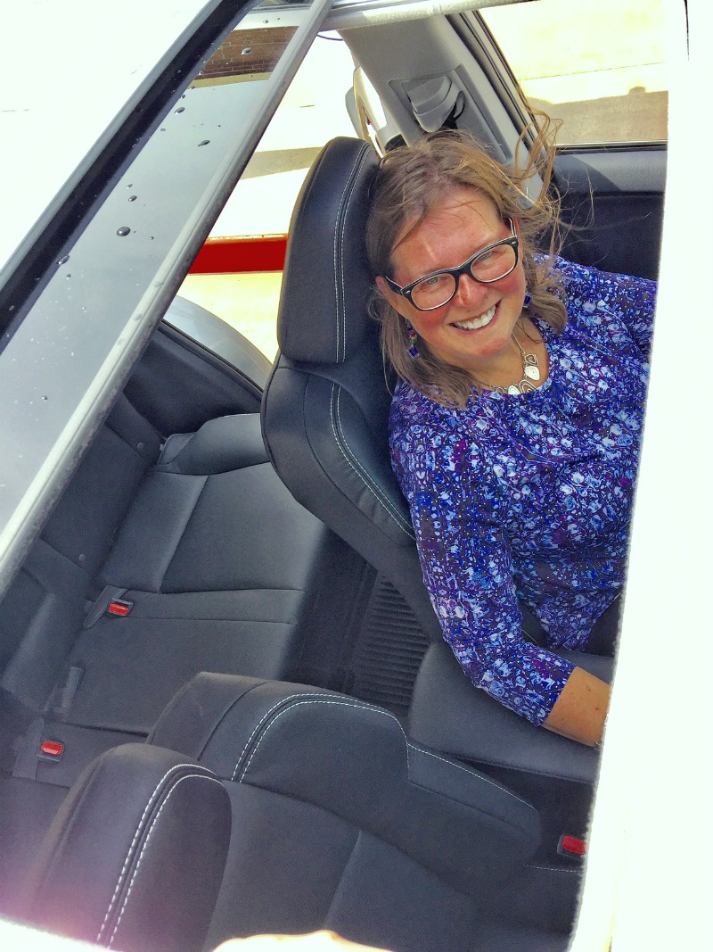 Author Cindy Richards peers out through the Toyota Rav4 sunroof.