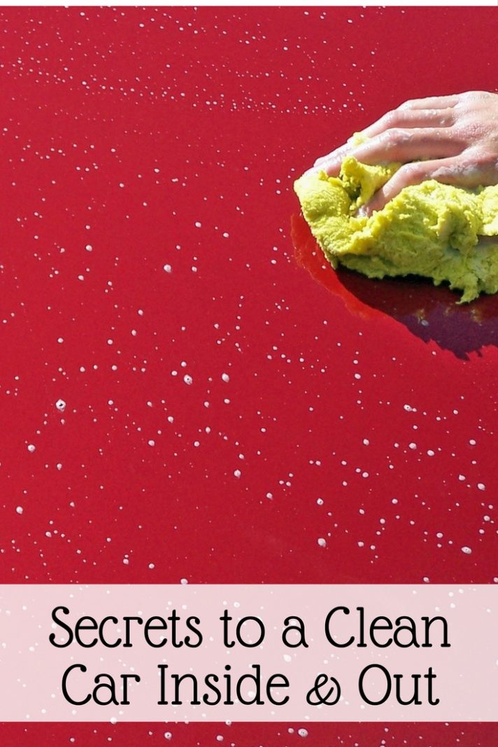 A sponge cleaning the exterior of a red car hood