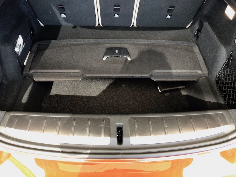 The hidden floor compartment in the BMW X2, gray interior.