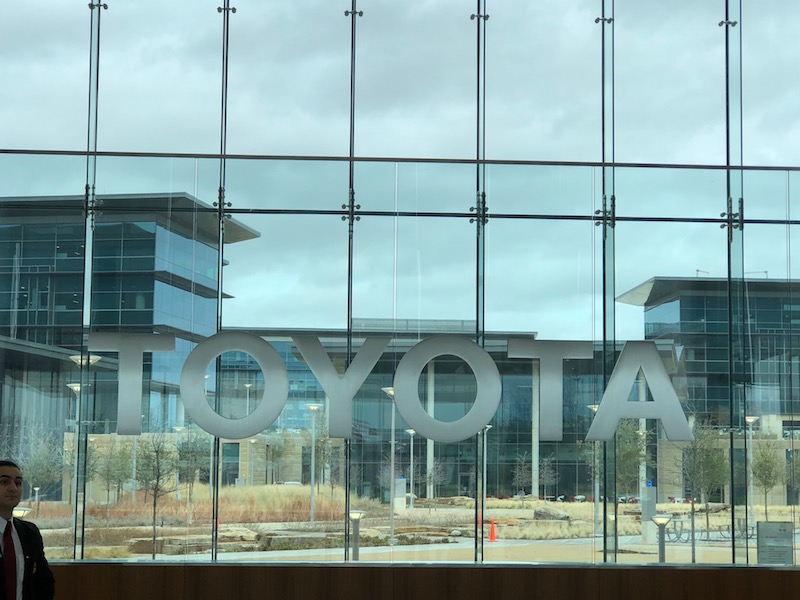 window with large Toyota logo in the middle of it 