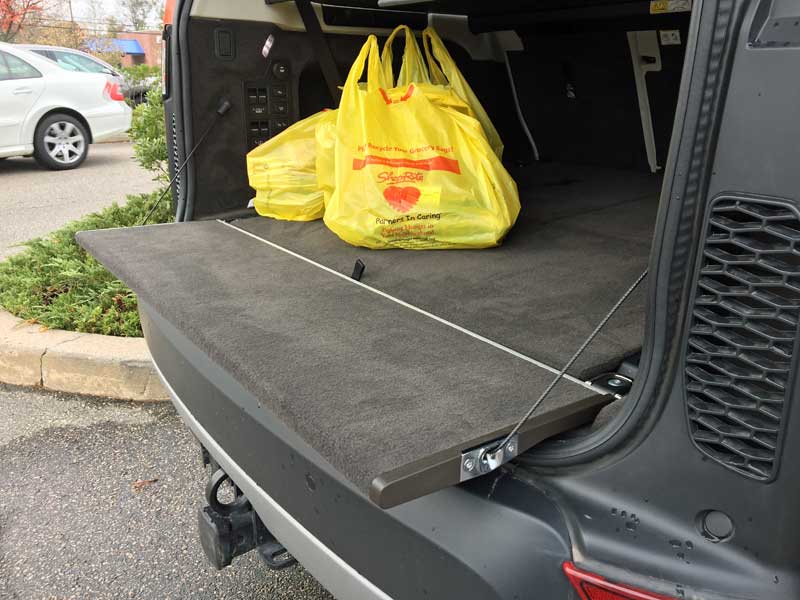 Inner liftgate with gray interior in the Land Rover Discovery with yellow grocery bags.