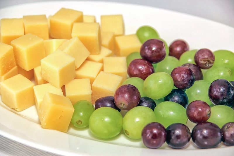 Road Trip and After School Snacks For Toddlers. Cut yellow cheese cubes with green and purple grapes. 