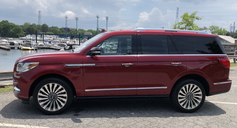 Red Lincoln Navigator sitting water front 