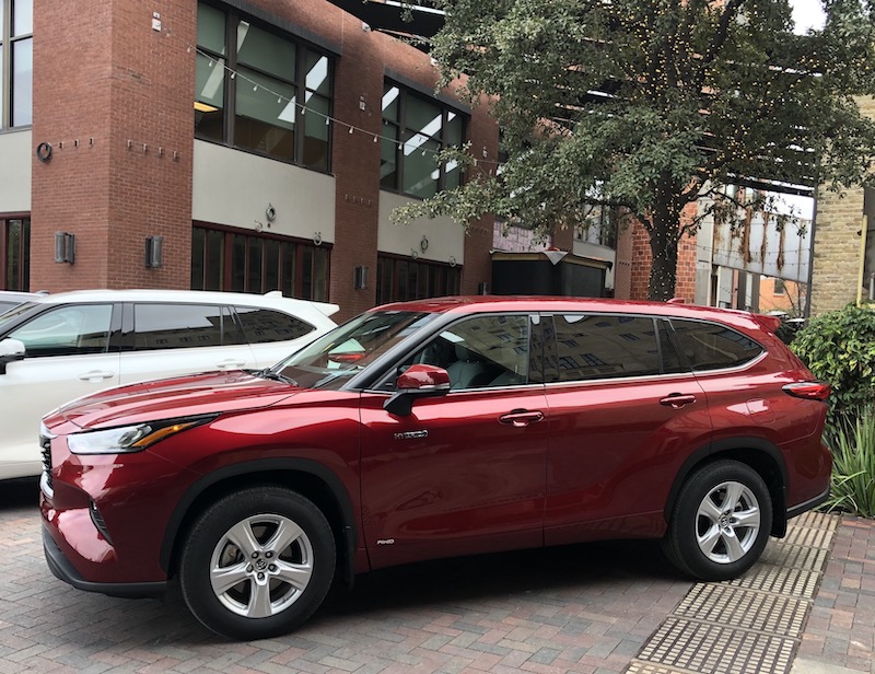 Red Toyota Highlander sits outside of businesses 