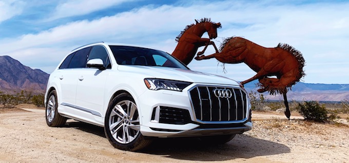 2020 audi q7 parked in front of a horse sculpture 