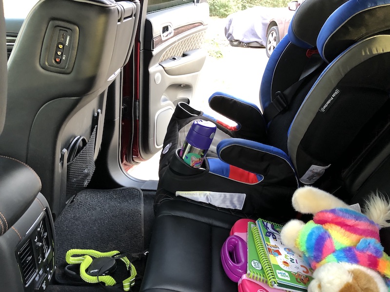 backseat of car with kids stuff 