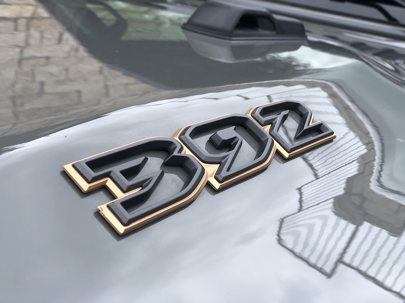 The 392 logo framed in gold chrome on the Jeep Wrangler 392