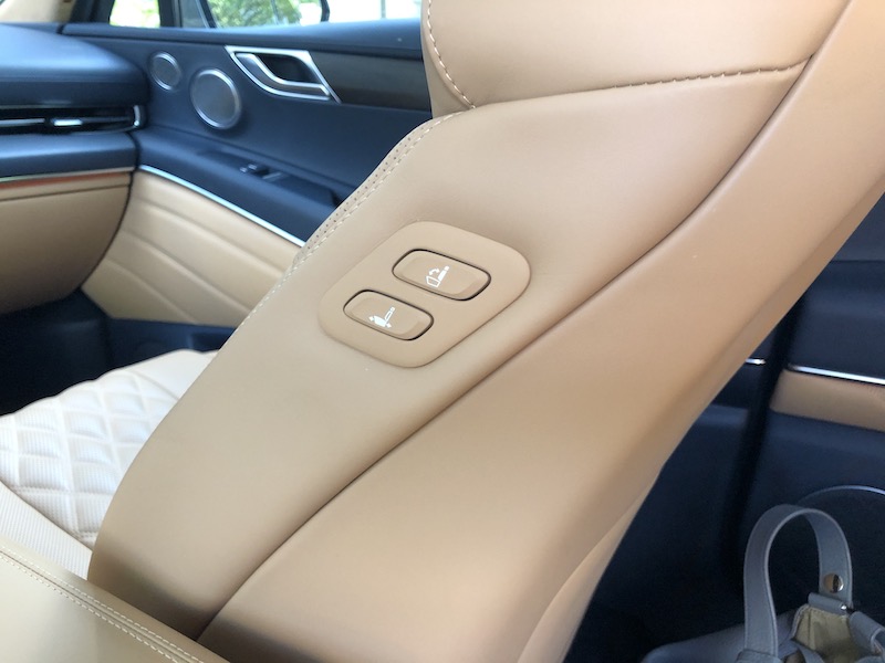 Rear seat passengers can use these buttons to move the front passenger seat forward or back