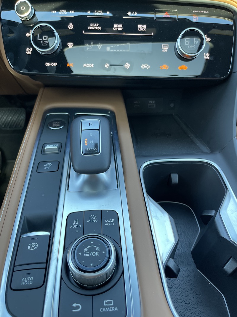 The Infiniti QX 60's command center drive modes, gear selector and a dial controller for the media screen