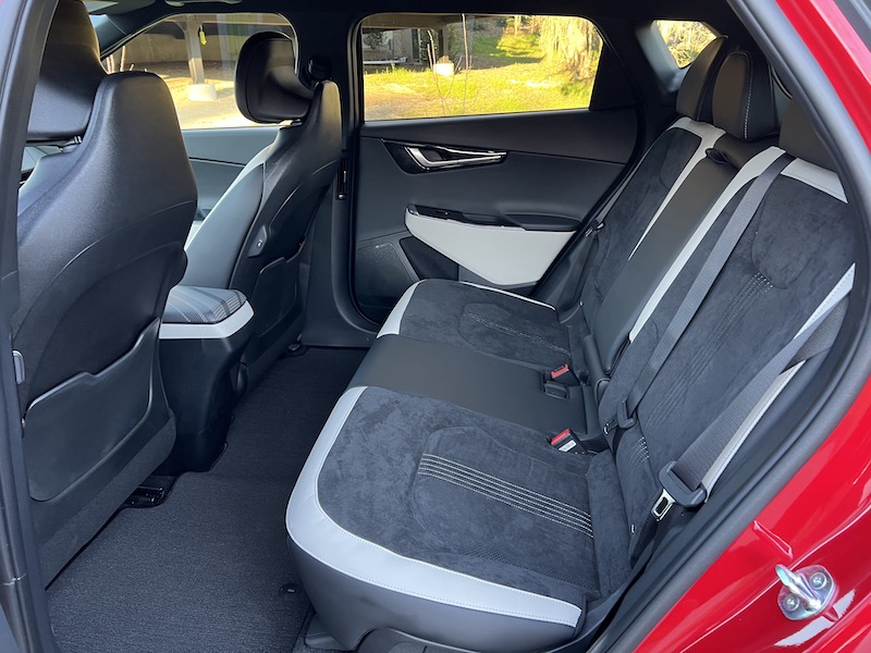 The Kia EV6 rear seat is really spacious; note also, the unusual headrest design on the front seats