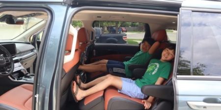 Two kids in the second row of the Kia Carnival MPV