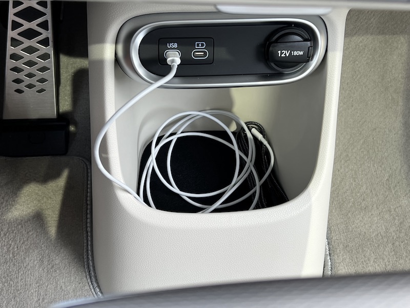 A bin under the dashboard allows for storage and charging