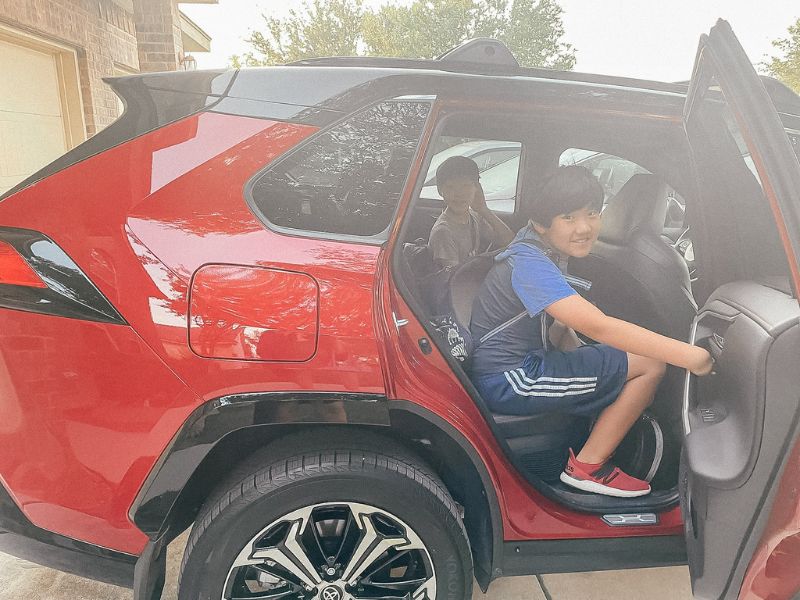 two kids in the back of a 2022 Toyota RAV4 plug in hybrid