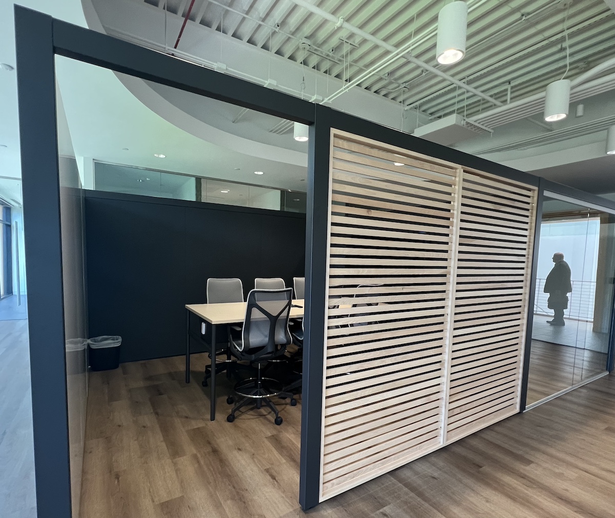 A Semi-Private Feeling Is Created For This Meeting Room With An Open Top And A Louvered Wall
