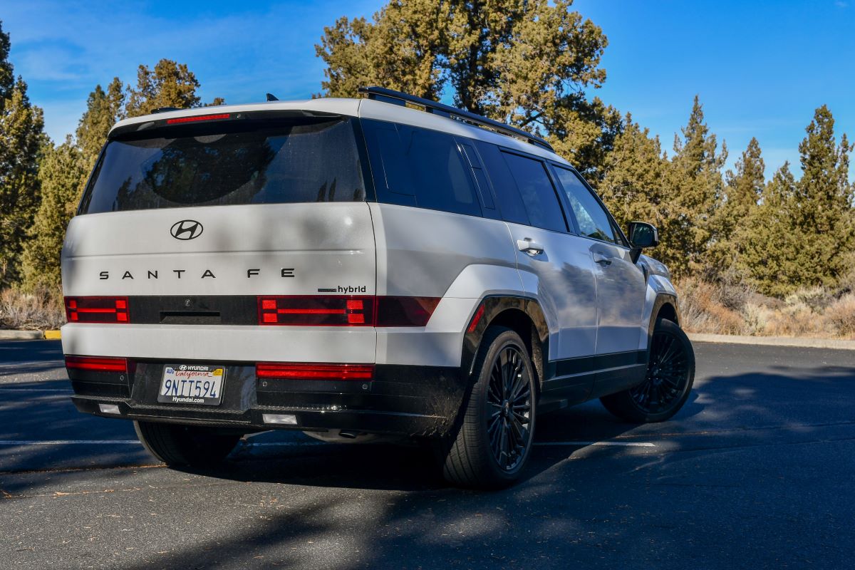 The 2024 Hyundai Santa Fe Hybrid Review: This Car is So Good My Husband Wants One ASAP 4 The Rear End Of The 2024 Hyundai Santa Fe Calligraphy Hybrid Parked In A Woodsy Parking Lot