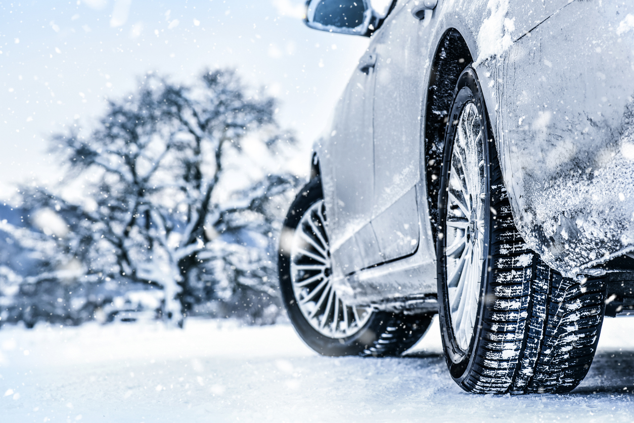 A Car With Snow Tires Is Parked On Ice To Show Tread Depth And Tire Detail