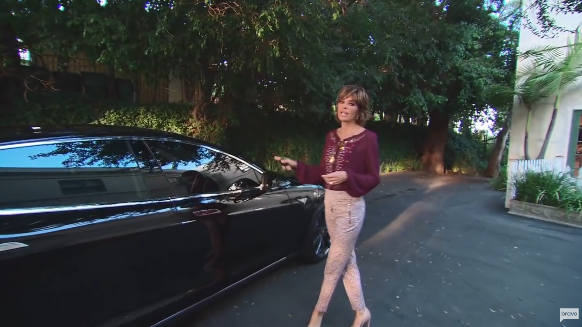 Real Wheels: What the Real Housewives of Beverly Hills Drive 7 Sutton Stracke Standing In Front Of Her Tesla Model S P85