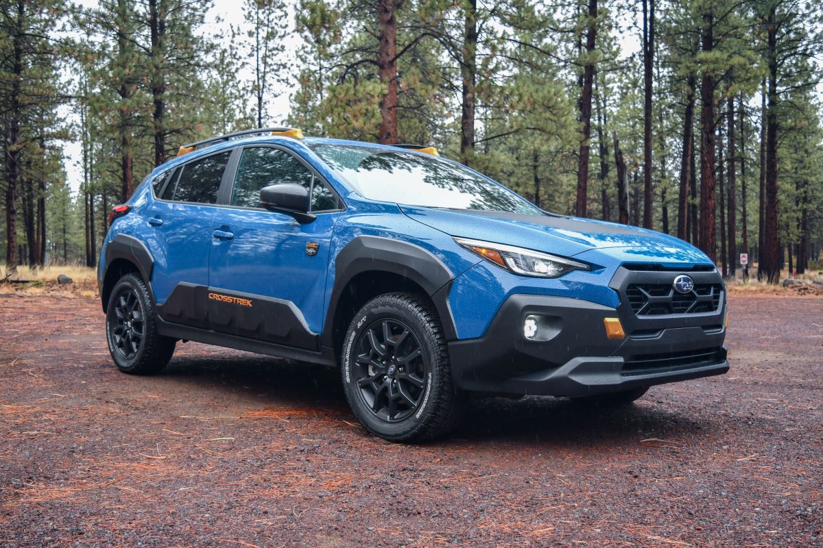 These are the Best Budget Trucks and SUVs Under $30,000—or Really, Sub-$27K For Wiggle Room 5 The 2024 Subaru Crosstrek Wilderness Parked On A Rainy, Dirt Road