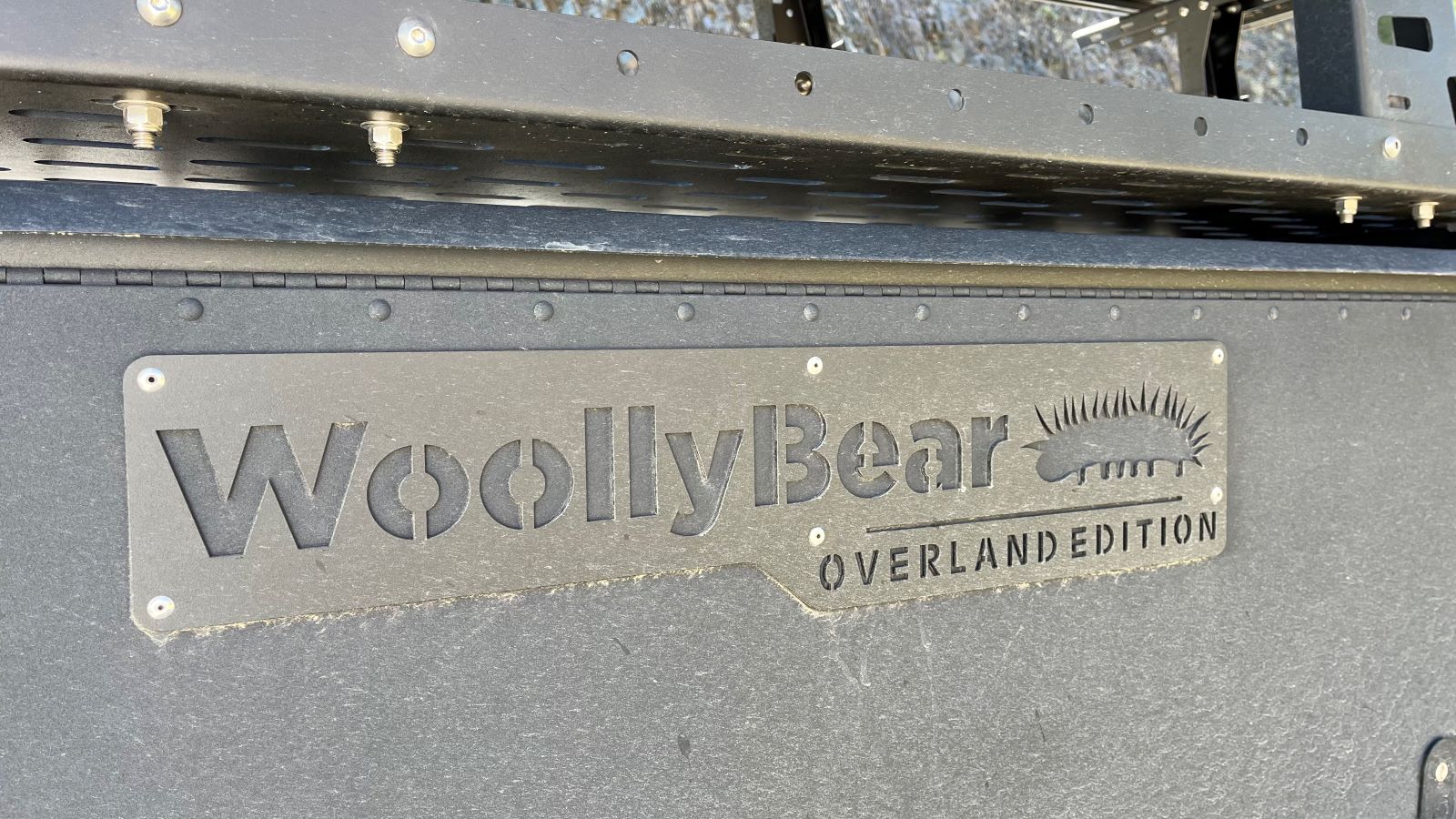 A Bear In Your Campground?!? If It's The Taxa Woolly Bear Camper Trailer, You're in Luck 11 The Emblem On The Side Of The Taxa Woolly Bear Camping Trailer Overland Edition